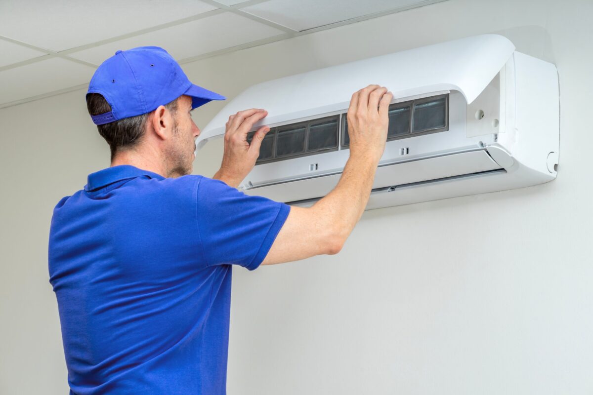 hvac technician working on a heat pump indoor unit