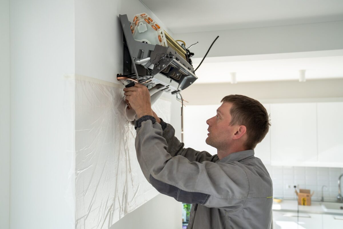 HVAC Technician working on indoor ac unit.